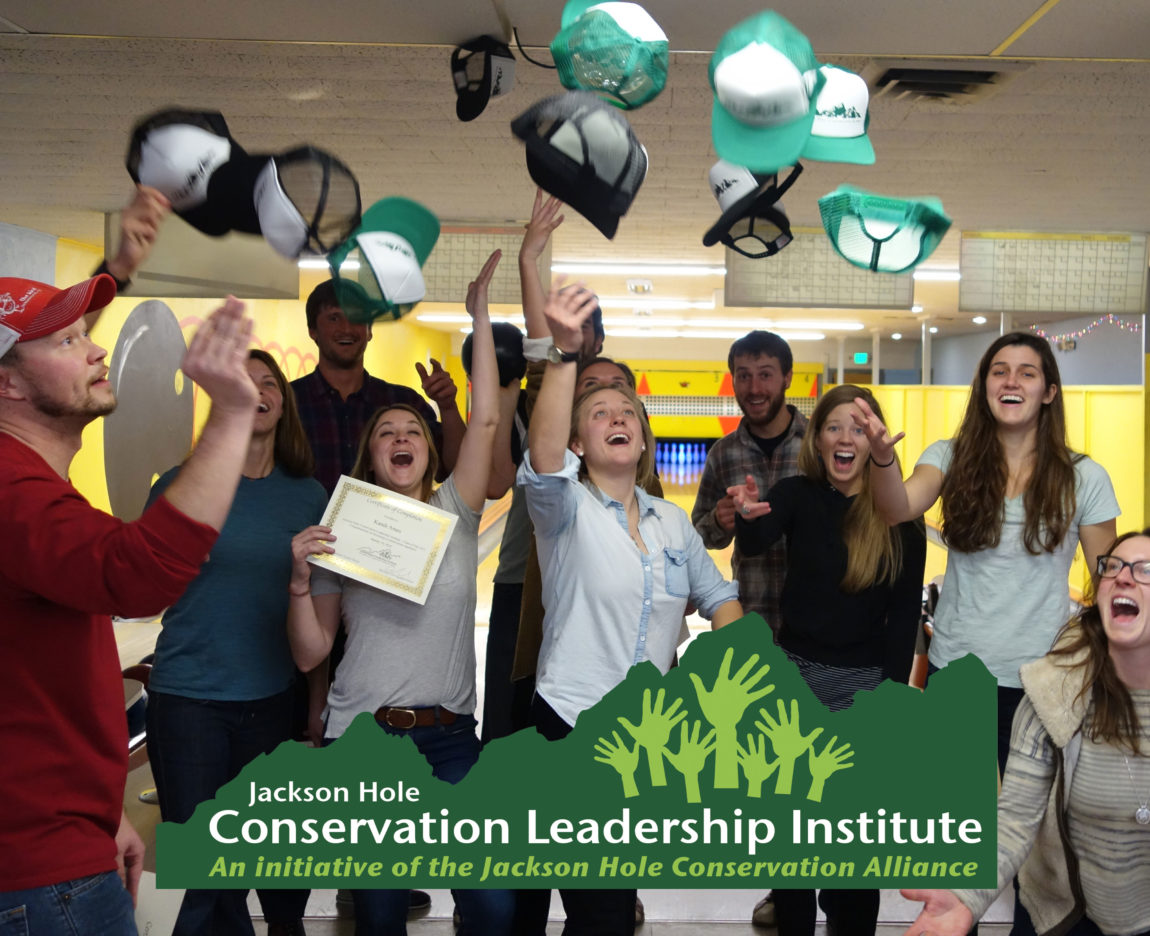CLI participants toss hats into the air to celebrate graduation from the program.